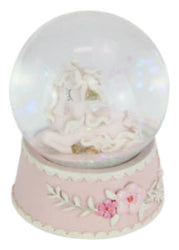 Snow globe with a pink base featuring floral designs on a white background
