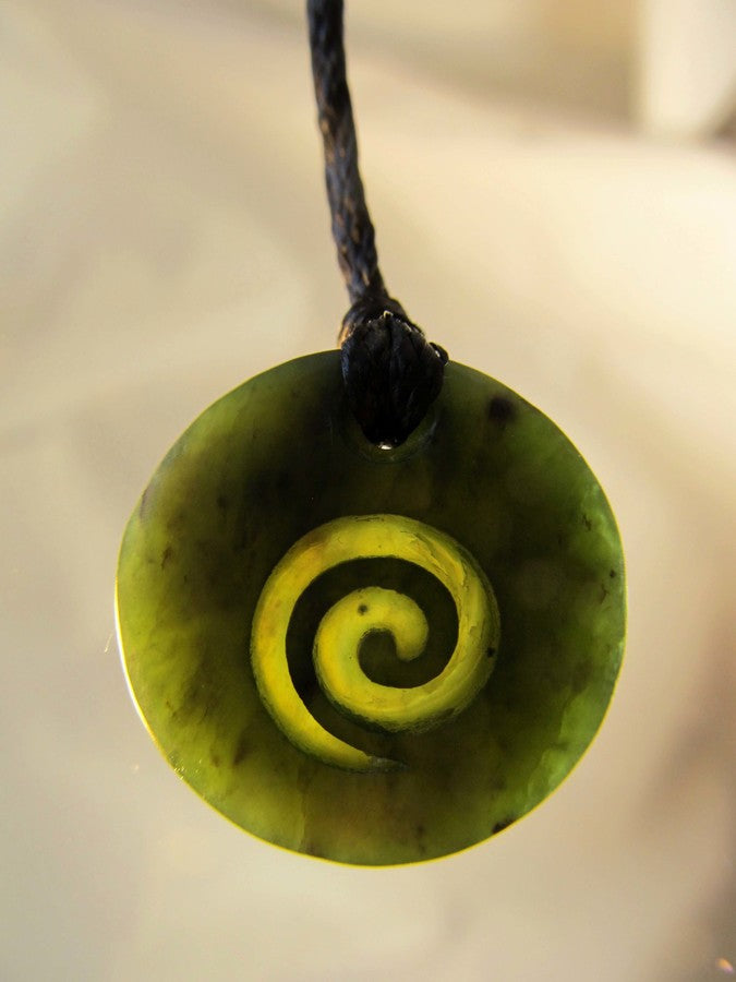 ROUND GREENSTONE PENDANT WITH KORU CARVED INTO IT