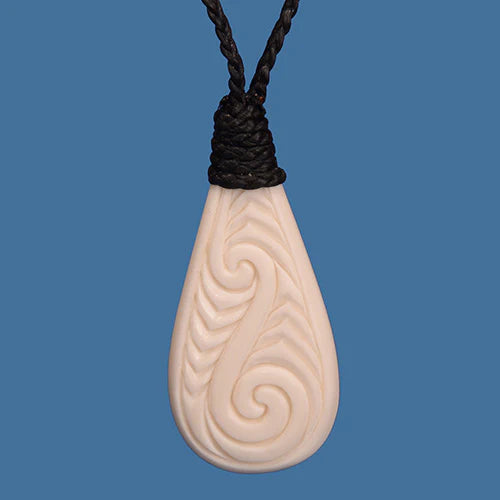 Bone Tear Drop Pendant with Koru pattern work.